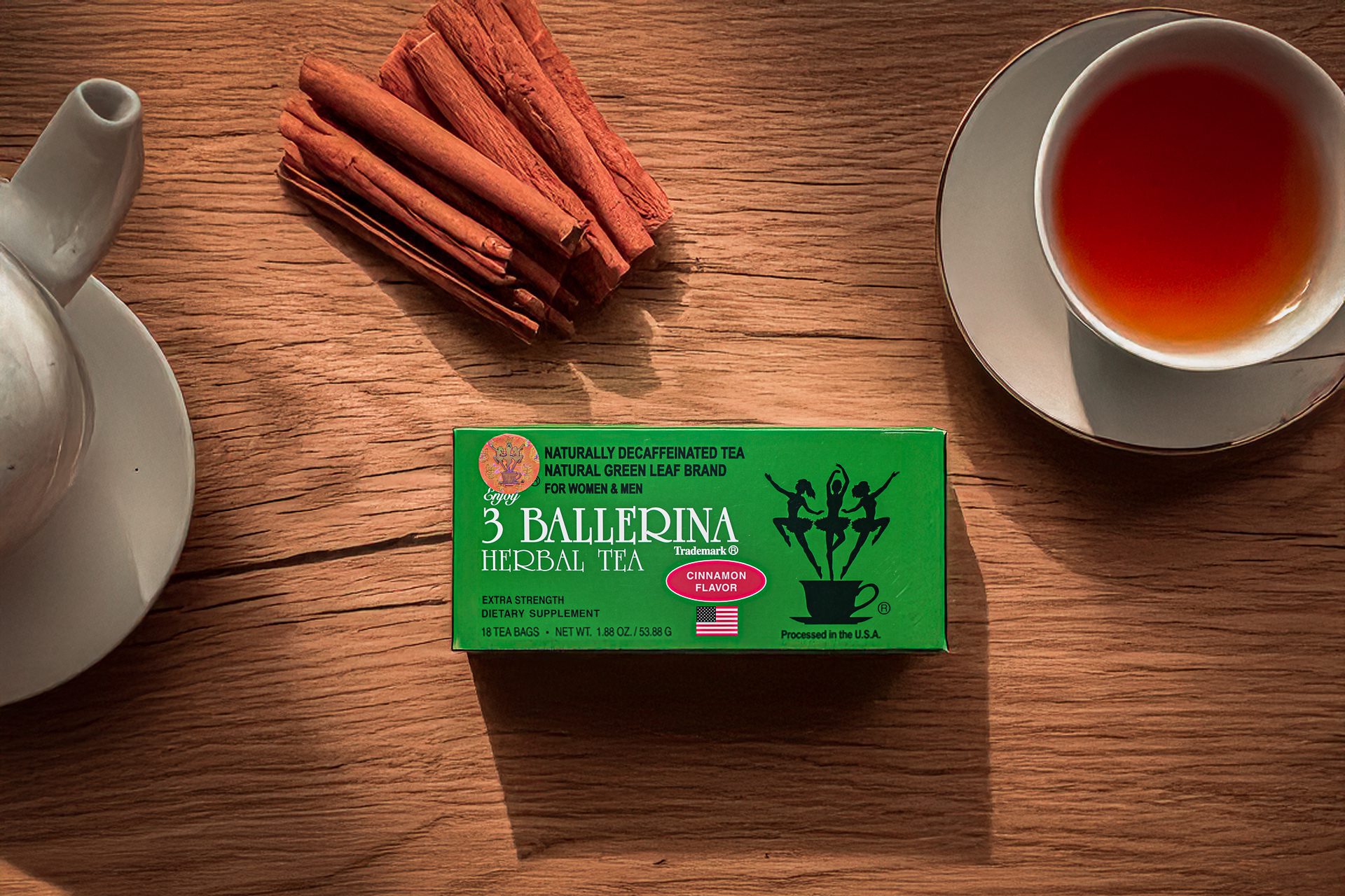 3 Ballerina cinnamon flavor herbal tea box with brewed tea cup and cinnamon sticks on wooden surface