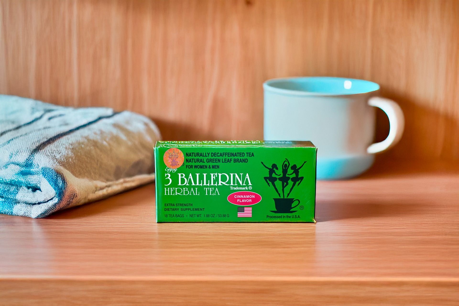 3 Ballerina cinnamon flavor herbal tea box on wooden shelf with tea cup